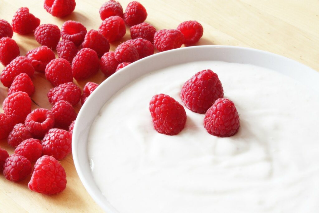 Bílý řecký jogurt s malinami a hubnutí.